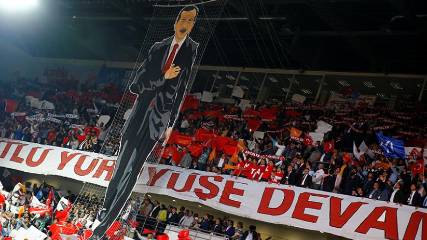A banner depicting Turkey's President Tayyip Erdogan is seen during the Extraordinary Congress of the ruling AK Party (AKP) to choose the new leader of the party, in Ankara, Turkey May 22, 2016. REUTERS/Umit Bektas - RTSFD8J