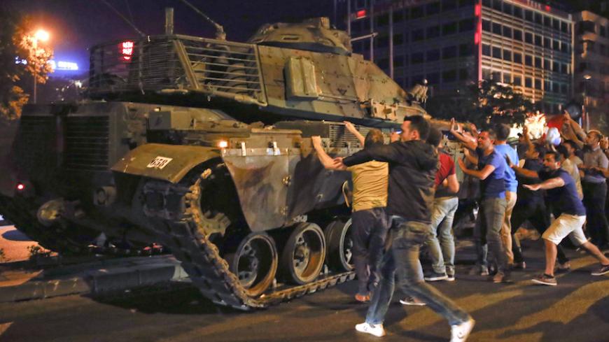 People react near a military vehicle during an attempted coup in Ankara, Turkey, July 16, 2016. REUTERS/Tumay Berkin TPX IMAGES OF THE DAY - RTSI82W