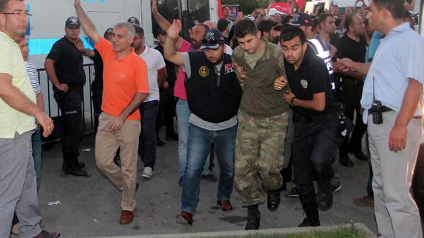 Soldiers suspected of being involved in the coup attempt are escorted by policemen as they arrive at a courthouse in the resort town of Marmaris, Turkey, July 17, 2016. REUTERS/Kenan Gurbuz - RTSIFAO