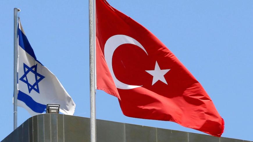 A Turkish flag flutters atop the Turkish embassy as an Israeli flag is seen nearby, in Tel Aviv, Israel June 26, 2016.  REUTERS/Baz Ratner/File Photo - RTSOQGS
