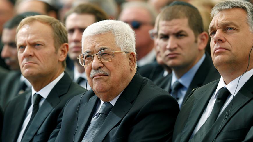 Palestinian President Mahmoud Abbas (C) sits alongside European Council President Donald Tusk (L) as they attend the funeral of Shimon Peres, 93, on Mount Herzl Cemetery in Jerusalem, September 30, 2016. REUTERS/Abir Sultan/Pool - RTSQ58E