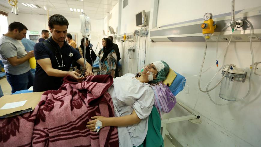A woman, who was wounded in a bombing at a Kurdish wedding in the northeast Syrian city of Hasaka, lies in a hospital in Dohuk province, Iraq, October 4, 2016. REUTERS/Ari Jalal - RTSQP7M
