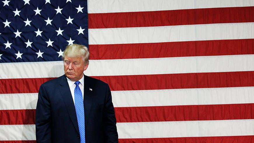 Republican presidential nominee Donald Trump pauses as he speaks at a campaign town hall event in Sandown, New Hampshire, U.S., October 6, 2016.  REUTERS/Mike Segar - RTSR4I8