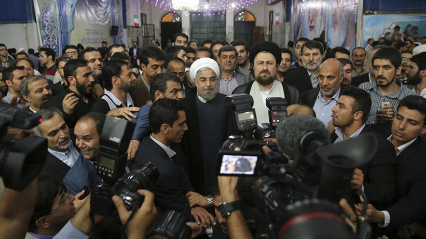 Iranian President-elect Hassan Rouhani (C) speaks to the media following a visit to the Khomeini mausoleum in Tehran June 16, 2013. Reuters/Fars News/Seyed Hassan Mousavi   (IRAN - Tags: POLITICS) ATTENTION EDITORS - THIS IMAGE WAS PROVIDED BY A THIRD PARTY. FOR EDITORIAL USE ONLY. NOT FOR SALE FOR MARKETING OR ADVERTISING CAMPAIGNS. THIS PICTURE IS DISTRIBUTED EXACTLY AS RECEIVED BY REUTERS, AS A SERVICE TO CLIENTS - RTX10Q47