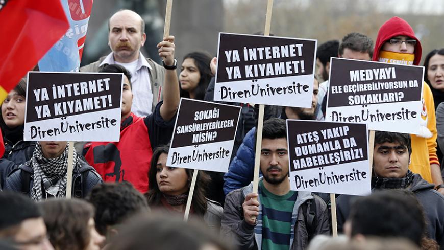 Protesters hold signs and wave flags as they demonstrate against new controls on the Internet approved by the Turkish parliament in Ankara February 22, 2014. The signs read, ''Internet of Doomsday!", "It is impossible to sensor the streets!" and "You can have your own media but you can't get the streets''. REUTERS/Umit Bektas (TURKEY - Tags: POLITICS SCIENCE TECHNOLOGY CIVIL UNREST CRIME LAW) - RTX19AYE