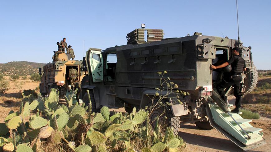 Tunisian soldiers and police patrol the area of Mount Salloum near Algeria's border in Kasserine, Tunisia July 4, 2015. Tunisian President Beji Caid Essebsi declared a state of emergency on Saturday, saying the Islamist militant attack on a beach hotel that killed 38 foreigners had left the country "in a state of war". Picture taken July 4, 2015. REUTERS/Stringer - RTX1J484