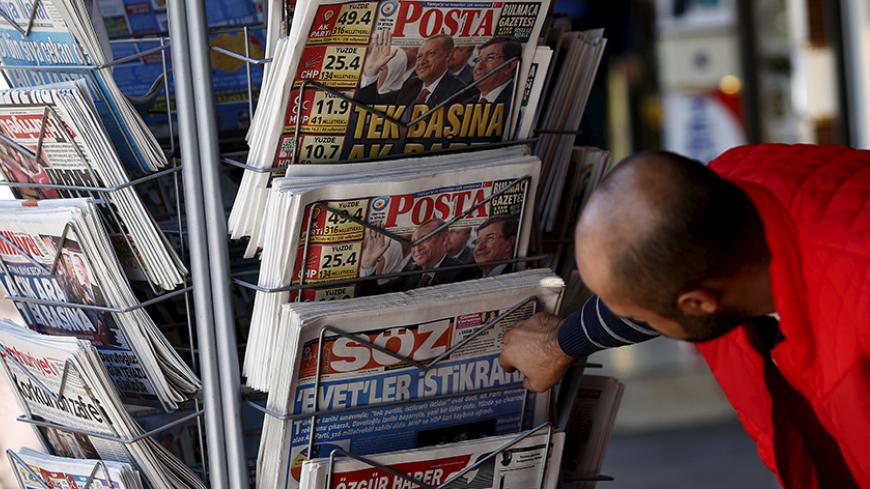A man looks at newspapers at a kiosk in Diyarbakir, Turkey November 2, 2015. Turkish President Tayyip Erdogan said on Monday the nation had voted for stability in a parliamentary election that saw the AK Party he founded win almost 50 percent of the vote, and said the world should respect the result. REUTERS/Stoyan Nenov - RTX1UCZZ