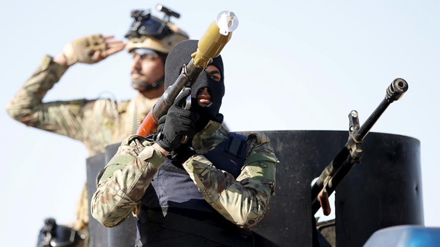 Iraqi Sunni Muslim fighters from Hashid Shaabi (Popular Mobilization) take part in a parade during a ceremony marking the Iraqi Police Day at Amiriyat al-Fallujah in Anbar province, January 9, 2016. REUTERS/Thaier Al-Sudani - RTX21NHG