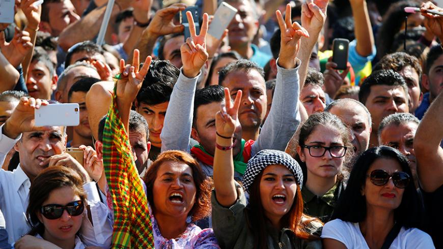Traditionally dressed Kurdish women flash victory signs during a rally of some 30,000 Turkish Kurds pro PKK leader (Kurdistan Workers' Party) Abdullah Ocalan and and against Turkish President and AKP party leader Recep Tayyip Erdogan in Cologne, Germany September 3, 2016. REUTERS/Wolfgang Rattay        TPX IMAGES OF THE DAY      - RTX2NZJL