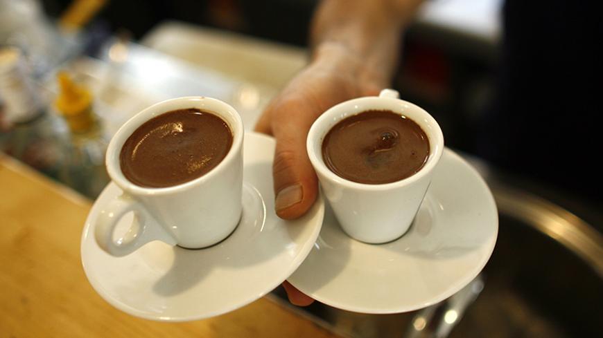 A waiter carries two cups of Turkish coffee at a coffee shop in Istanbul October 19, 2007. Turks are turning their backs on traditional Turkish coffee as they acquire a taste for the cappuccinos and espressos served at global coffee chain outlets opening up across this economically booming Muslim country. Picture taken October 19, 2007. To match feature TURKEY-COFFEE      REUTERS/Osman Orsal   (TURKEY) - RTX7D