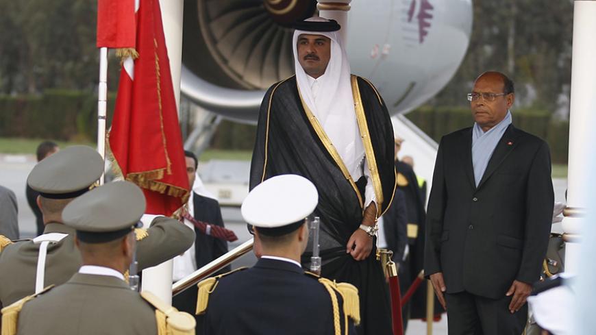 Tunisia's President Moncef Marzouki (R) and Qatar's Emir Sheikh Tamim bin Hamad al-Thani listen to their national anthems during a welcome ceremony in Tunis April 3, 2014. REUTERS/Zoubeir Souissi (TUNISIA - Tags: POLITICS ROYALS) - RTR3JUGT
