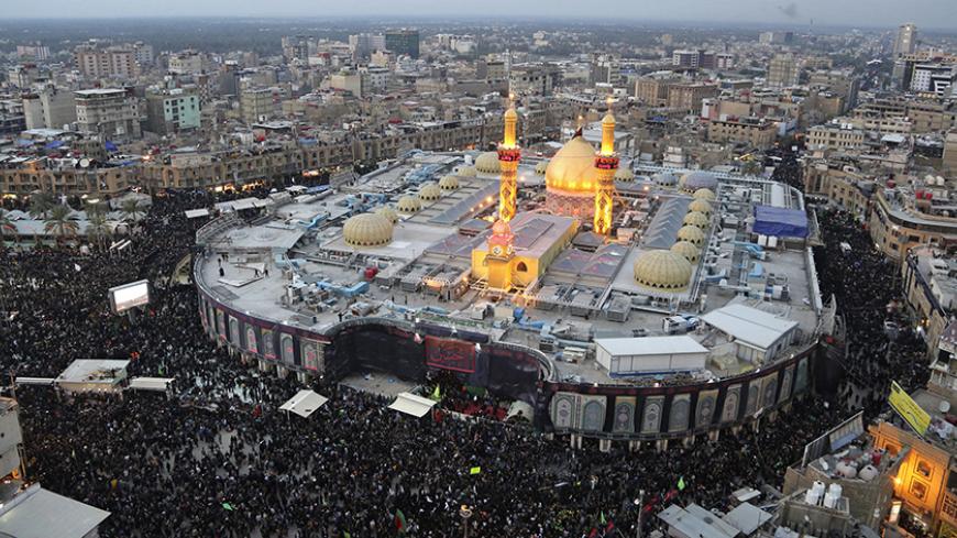 An aerial view shows the Shrine of Imam al-Abbas during the commemoration of Arbain in Kerbala, southwest of Baghdad December 13, 2014. Iraqi officials say millions of Shi'ite pilgrims from across Iraq and neighbouring countries are expected in Kerbala for Saturday's Arbain ritual, which marks the last of 40 days of mourning for the death of Imam Hussein that happened around 1,300 years ago. REUTERS/Abdul-Zahra (IRAQ - Tags: RELIGION SOCIETY CITYSCAPE) - RTR4HW0P