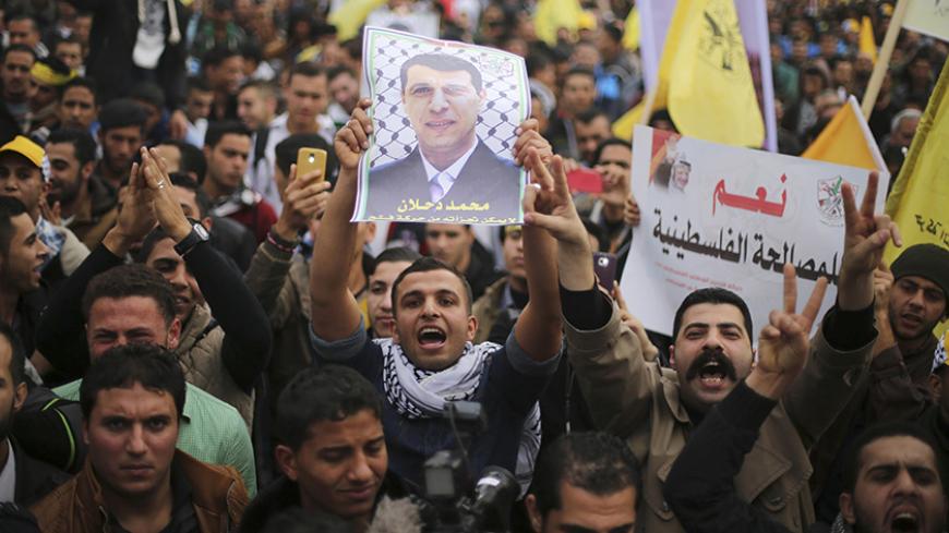 A Palestinian supporter of former head of Fatah in Gaza, Mohammed Dahlan, holds a poster depicting Dahlan during a protest against Palestinian President Mahmoud Abbas in Gaza City December 18, 2014. Dahlan, who lives in exile in the Gulf, is a powerful political foe of Abbas.
REUTERS/Mohammed Salem (GAZA - Tags: POLITICS CIVIL UNREST) - RTR4IJ8R