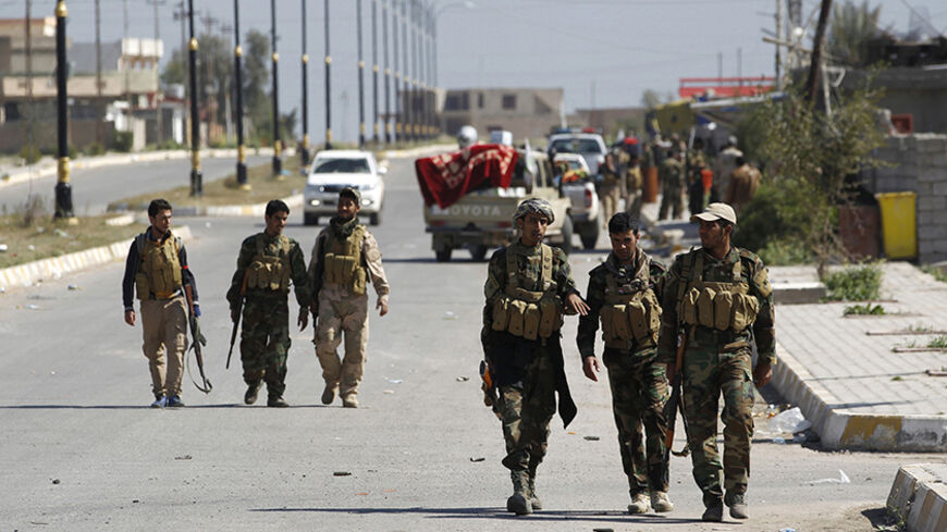 Militias known as Hashid Shaabi gather in the streets of the town of al-Alam March 10, 2015.  Iraqi troops and militias drove Islamic State insurgents out of the town of al-Alam on Tuesday, clearing a final hurdle before a planned assault on Saddam Hussein's home city of Tikrit in their biggest offensive yet against the ultra-radical group.  REUTERS/Thaier Al-Sudani (IRAQ - Tags: POLITICS CIVIL UNREST CONFLICT) - RTR4STTA