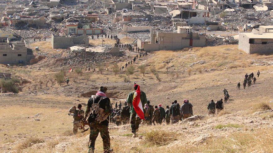 Members of the Kurdish peshmerga forces gather in the town of Sinjar, Iraq November 13, 2015. Kurdish peshmerga forces secured several strategic facilities in the northern Iraqi town of Sinjar on Friday as part of an offensive against Islamic State militants that could provide critical momentum in efforts to defeat the jihadist group. REUTERS/Ari Jalal FOR EDITORIAL USE ONLY. NO RESALES. NO ARCHIVE.      TPX IMAGES OF THE DAY      - RTS6S32