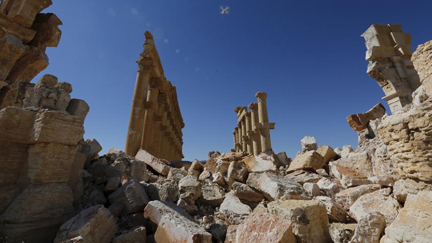 A view shows the damage at the Monumental Arch in the historical city of Palmyra, in Homs Governorate, Syria April 1, 2016. REUTERS/Omar Sanadiki SEARCH "PALMYRA SANADIKI" FOR THIS STORY. SEARCH "THE WIDER IMAGE" FOR ALL STORIES - RTSD6WL