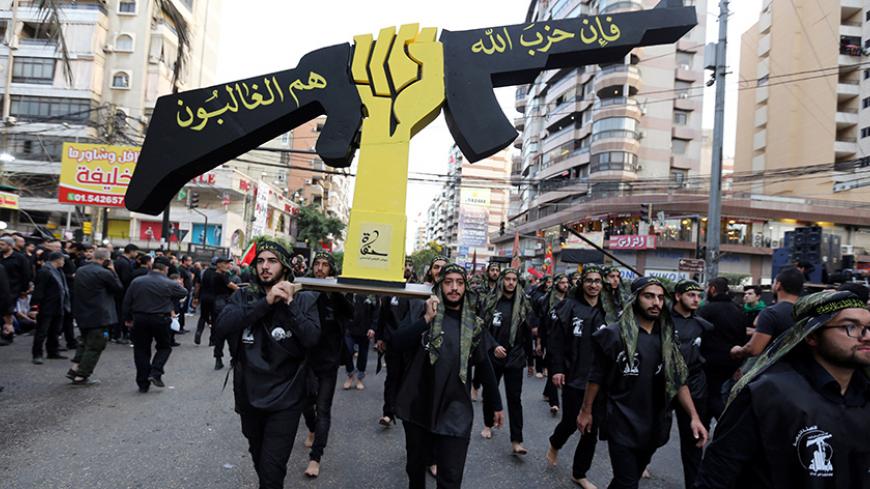 Lebanese Hezbollah supporters carry a replica of Hezbollah emblem during a religious procession to mark Ashura in Beirut's southern suburbs, Lebanon October 12, 2016. REUTERS/Aziz Taher - RTSRWQ6