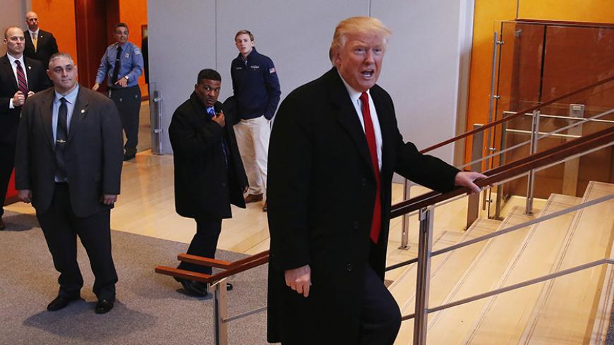 U.S. President elect Donald Trump walks up a staircase to depart the lobby of the New York Times building after a meeting in New York, U.S., November 22, 2016. REUTERS/Lucas Jackson - RTSSUCX