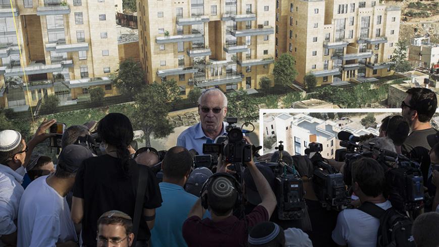 Israeli Housing Minister Uri Ariel speaks to reporters at a ceremony announcing the resumption of construction of an Israeli neighbourhood in East Jerusalem August 11, 2013. Israel moved forward on Sunday with plans to build nearly 1,200 new homes for Jewish settlers holding fast to a defiant settlement policy just days before its expected release of Palestinian prisoners. REUTERS/Ronen Zvulun (JERUSALEM - Tags: POLITICS) - RTX12HFR