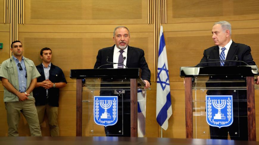 Israeli prime minister Benjamin Netanyahu (R) listens as Israel's new Defence Minister Avigdor Lieberman, head of far-right Yisrael Beitenu party, speaks during a media conference following Lieberman's swearing-in ceremony at the Knesset, the Israeli parliament, in Jerusalem May 30, 2016. REUTERS/Ronen Zvulun TPX IMAGES OF THE DAY - RTX2EVP3