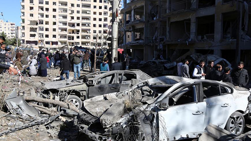 People look at buildings and cars, which were damaged during Friday's car bomb attack, in the  Kurdish-dominated southeastern city of Diyarbakir, Turkey, November 5, 2016. REUTERS/Sertac Kayar - RTX2S0OF
