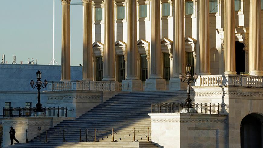 A security guard stands on the step to the House of Representatives at the U.S. Capitol in Washington, U.S., November 7, 2016. REUTERS/Joshua Roberts - RTX2SCP1