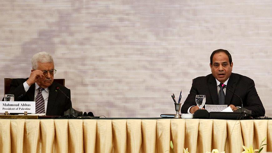 Palestinian President Mahmoud Abbas (L) and Egyptian President Abdel Fattah al-Sisi attend a Gaza reconstruction conference in Cairo October 12, 2014. Egypt, which brokered a ceasefire between Israel and the Palestinians in Gaza after a 50-day war, used a reconstruction conference in Cairo on Sunday to call for a wider peace deal based on a 2002 Arab initiative.  REUTERS/Mohamed Abd El Ghany (EGYPT - Tags: POLITICS) - RTR49UU5