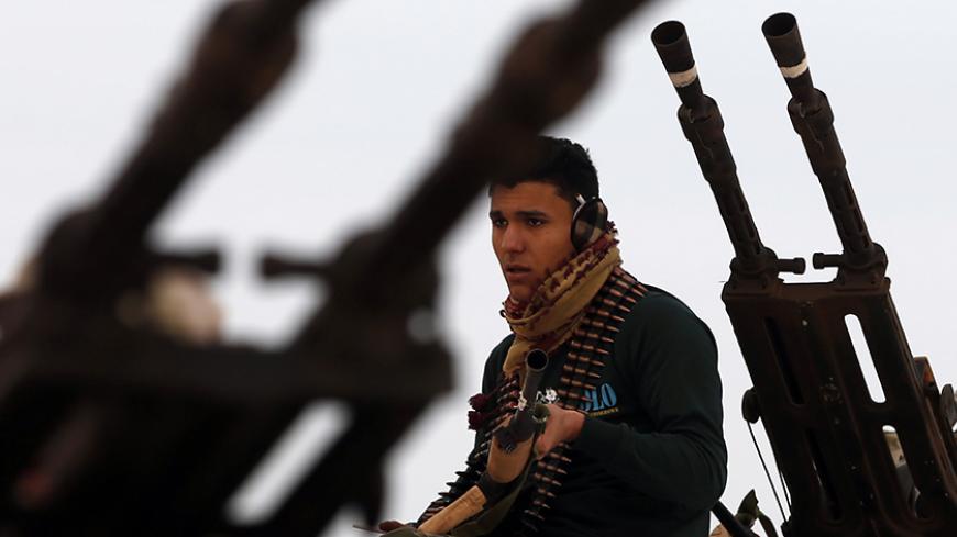 A fighter from Misrata sits on top of a vehicle near Sirte March 16, 2015. REUTERS/Goran Tomasevic (LIBYA - Tags: CIVIL UNREST TPX IMAGES OF THE DAY) - RTR4TJRG