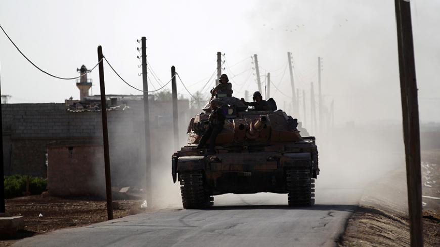 A Turkish tank drives near Guzhe village, northern Aleppo countryside, Syria October 17, 2016. REUTERS/Khalil Ashawi - RTX2P87C