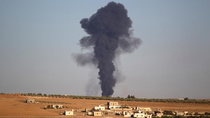 Smoke rises from al-Bab city, northern Aleppo province, Syria October 26, 2016. REUTERS/Khalil Ashawi - RTX2QLVW