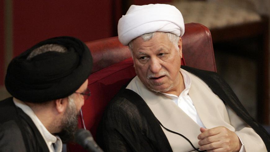 Top Iranian cleric Ahmad Khatami (L) speaks with former President Akbar Hashemi Rafsanjani during an opening session of the Assembly of Experts, a clerical body that supervises the performance of the Supreme Leader Ayatollah Ali Khamenei, in Tehran August 29, 2006.   
REUTERS/Raheb Homavandi (IRAN) - RTR1GSC2