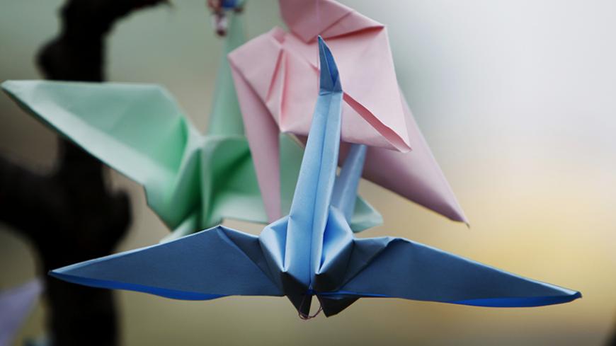 Origami birds hang from a tree in memory of victims of the magnitude 9.0 earthquake and tsunami which struck Japan last week, in the centre of Sofia, March 17, 2011. REUTERS/Oleg Popov (BULGARIA - Tags: DISASTER SOCIETY ENVIRONMENT) - RTR2K053