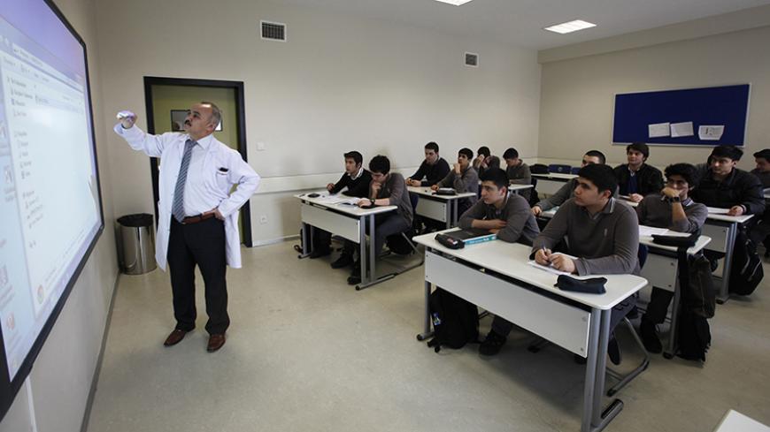 Students attend a geometry class at Fatih College in Istanbul February 21, 2014. Turkish leader Tayyip Erdogan, shaken by a graft scandal he says is concocted by a former ally, is fighting to secure his political future in the run up to March polls. But more than that, he sees at stake the legacy of an 11-year drive to reshape Turkey, breaking the hold of a secular, urban elite. Picture taken February 21, 2014. To match Insight TURKEY-ERDOGAN/ REUTERS/Osman Orsal (TURKEY - Tags: EDUCATION POLITICS RELIGION)