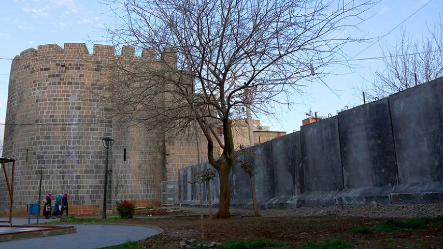 Concrete blocks are placed next to the historical city walls at the main entrance of Sur district, which is partially under curfew, in the Kurdish-dominated southeastern city of Diyarbakir, Turkey March 17, 2016. REUTERS/Sertac Kayar - RTSAV57