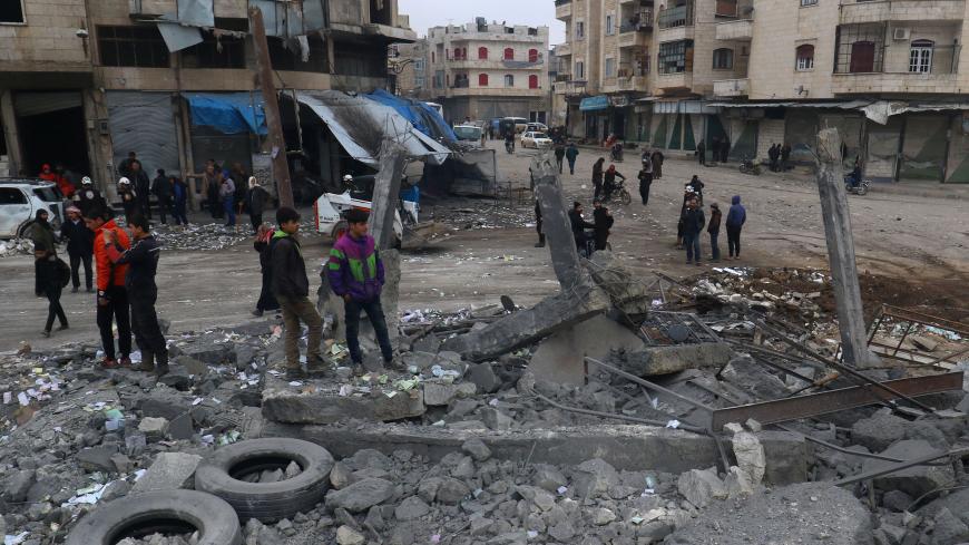 People inspect a site hit by airstrikes at a parking garage in the rebel-held city of Idlib, Syria January 18, 2017. REUTERS/Ammar Abdullah - RTSW2U6