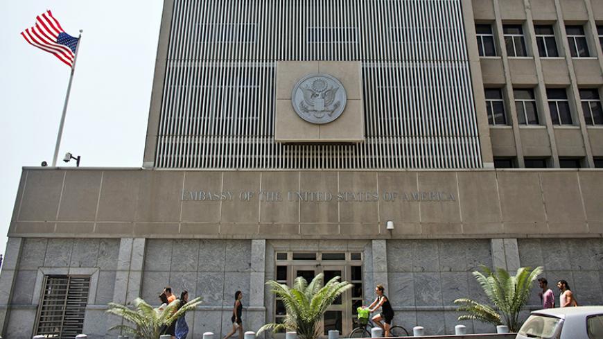 Pedestrians walk past the U.S. embassy in Tel Aviv August 2, 2013. U.S. embassies that would normally be open this Sunday - including those in Abu Dhabi, Baghdad and Cairo - will be closed that day because of unspecified security concerns, the U.S. State Department said on Thursday. CBS News said U.S. embassies would also be closed in Bahrain, Israel, Jordan, Kuwait, Libya, Oman, Qatar, Saudi Arabia, Yemen, Afghanistan and Bangladesh. REUTERS/Nir Elias (ISRAEL - Tags: POLITICS) - RTX12876