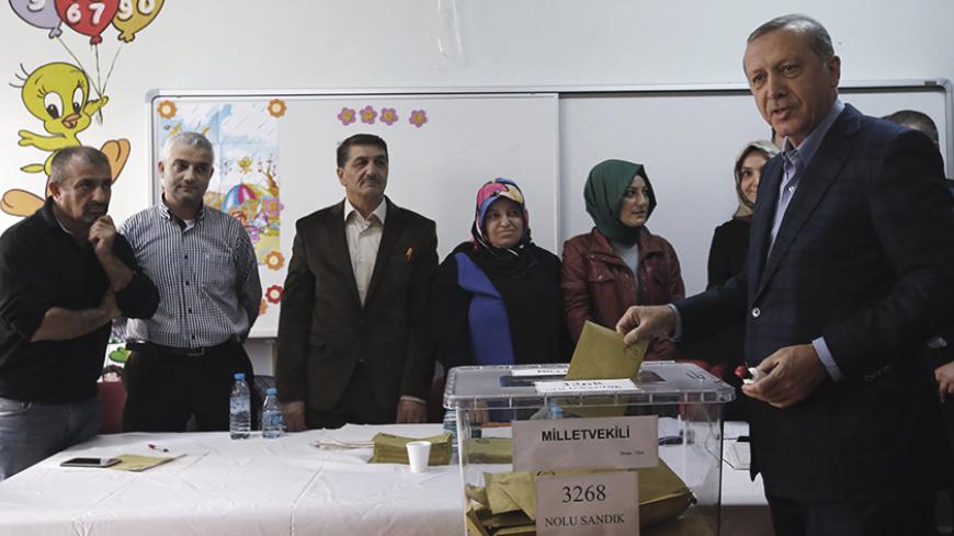 Turkish President Tayyip Erdogan poses as he casts his ballot at a polling station in Istanbul, Turkey November 1, 2015. Turks began voting on Sunday amid worsening security and economic worries in a snap parliamentary election that could profoundly impact the divided country's trajectory and that of President Tayyip Erdogan. The parliamentary poll is the second in five months, after the ruling AK Party founded by Erdogan failed to retain its single-party majority in June.  REUTERS/Murad Sezer   - RTX1U7U8