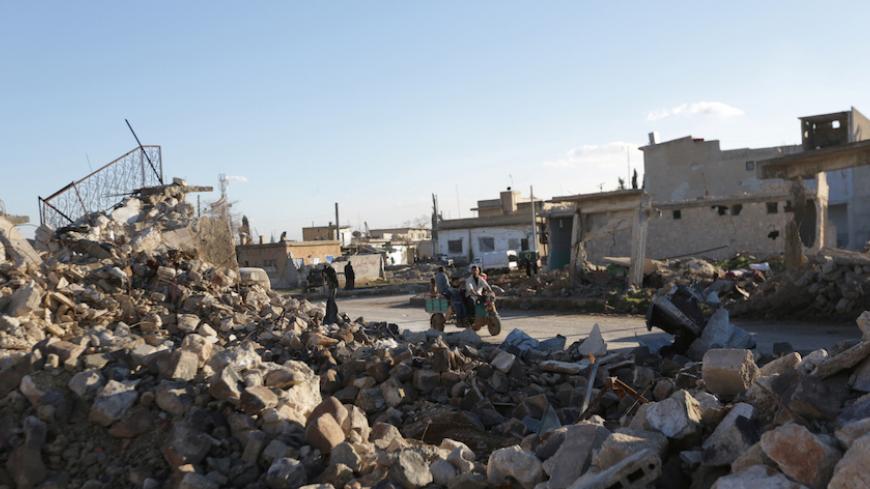 People drive a vehicle in al-Rai town, northern Aleppo countryside, Syria January 13, 2017. REUTERS/Khalil Ashawi - RTX2YTMK