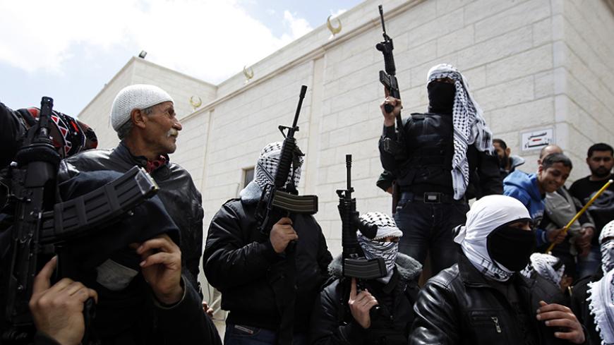 Masked Palestinian militants hold their weapons during the funeral of Maysara Abu Hamdeya in the West Bank city of Hebron April 4, 2013. Thousands of mourners turned out on Thursday for the funerals of three Palestinians, including two teenagers killed by Israeli army gunfire in some of the worst violence in the occupied West Bank in years. The upsurge in unrest was triggered on Tuesday by the death of Hamdeya, a 64-year-old prisoner serving a life term in an Israeli jail and suffering from cancer. REUTERS/