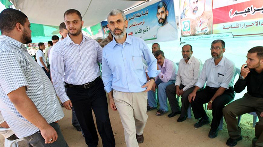 Freed Palestinian Hamas leader Yehia Sinwar (C) greets supporters following his release from an Israeli jail at a welcome tent near his home in Khan Yunis, southern Gaza Strip, on October 19, 2011. The Palestinian Hamas movement exchanged Gilad Shalit, the Israeli soldier who spent more than five years of isolation in a Gaza hide-out, for hundreds of Palestinian militants being held in Israeli jails. AFP PHOTO/SAID KHATIB (Photo credit should read SAID KHATIB/AFP/Getty Images)