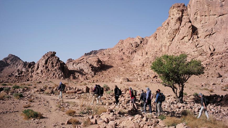 ST. CATHERINE, SINAI - APRIL 18: Bedouin guides lead tourists hiking through the mountains of South Sinai
on April 18, 2015 near St. Catherine, Egypt. Bedouins guides in the Sinai peninsula face stiff competition and many Sinai Bedouins are unemployed due to the lack of employment opportunities. (Photo by David Degner/Getty Images)