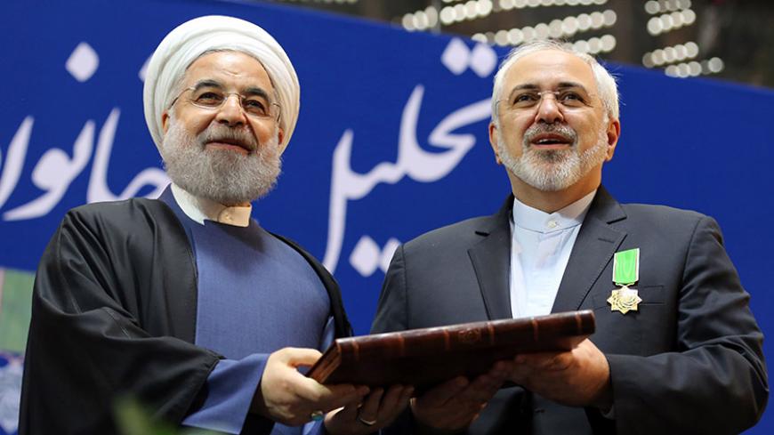 Iranian President Hassan Rouhani (L) awards Foreign Minister Mohammad Javad Zarif with the Medal of Honour for his role in the implementation of a nuclear deal with world powers, on February 8, 2016, in Tehran.  / AFP / ATTA KENARE        (Photo credit should read ATTA KENARE/AFP/Getty Images)