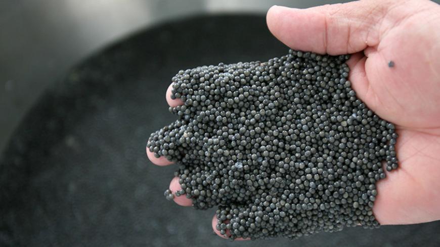 An inspector checks the quality of caviar before packaging in a sterile preparation room in Zibakenar 360km (223 miles) northwest of Tehran October 4, 2006. In April 2006 a U.N. body set up to safeguard endangered species said it was extending a ban on the export of caviar from the Caspian Sea for all countries except Iran. Iranians are trying to combat the demise of the sturgeon with ambitious networks of hatcheries, designed to replenish stocks by releasing millions of young fish each year. Environmentali