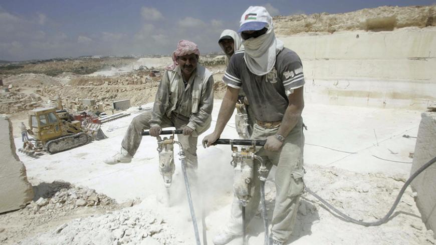 Palestinian labourers use jackhammers at a quarry in the West Bank village of Shioukh near Hebron April 10, 2007. Stone and marble factories and quarries, located mainly in the West Bank cities of Bethlehem and Hebron, are at the core of the Palestinian industrial sector. According to the Union of Stone and Marble Industry, the industry employs about 15,000 administrative, skilled and unskilled labourers. Picture taken April 10, 2007.
REUTERS/Nayef Hashlamoun (WEST BANK) - RTR1P0SM