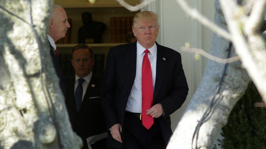 U.S. President Donald Trump walks out from the Oval Office of the White House in Washington, U.S., en route to CPAC, February 24, 2017. REUTERS/Yuri Gripas - RTS1060Z