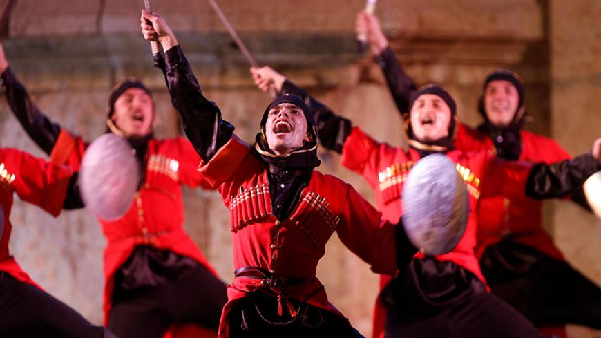 Dancers from the Ahli Club for Circassian Dance perform at the Southern theatre during the Jerash Festival of Culture and Arts in the ancient city of Jerash, north of Amman, Jordan, July 26, 2016. REUTERS/Muhammad Hamed - RTSJSOA
