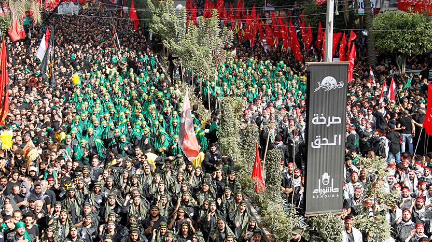 Lebanese Hezbollah supporters carry flags and gesture during a religious procession to mark Ashura in Beirut's southern suburbs, Lebanon October 12, 2016. REUTERS/Aziz Taher - RTSRWNQ