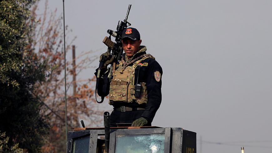 A member of the Iraqi Counter-Terrorism Service (CTS) stands in a military vehicle during a battle with Islamic State militants in east of Mosul, Iraq, January 21, 2017. REUTERS/Alaa Al-Marjani - RTSWPYD