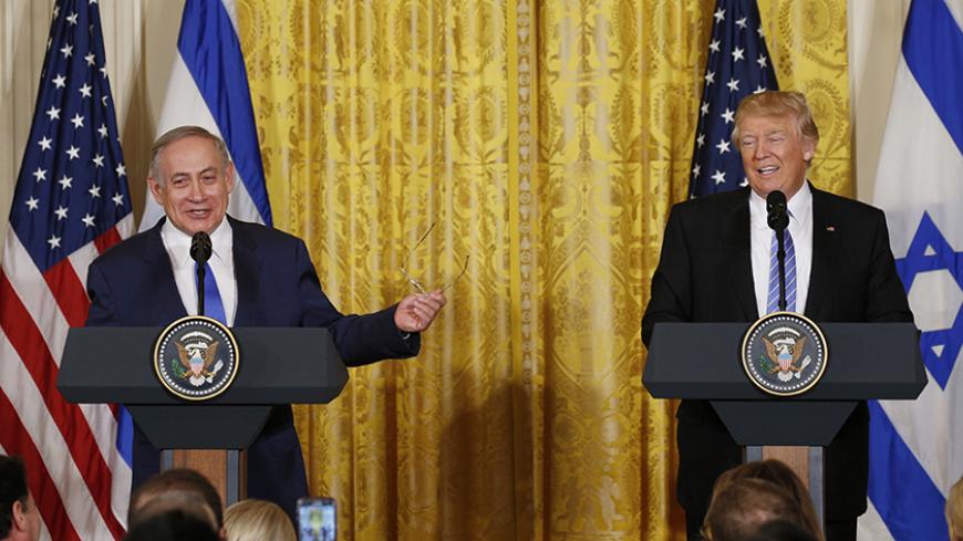 U.S. President Donald Trump (R) laughs with Israeli Prime Minister Benjamin Netanyahu at a joint news conference at the White House in Washington, U.S., February 15, 2017. REUTERS/Kevin Lamarque - RTSYUD8