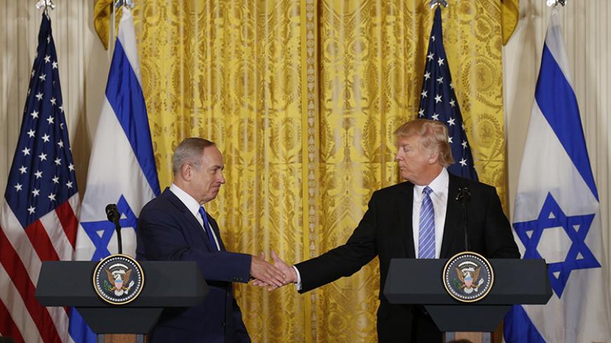 U.S. President Donald Trump (R) greets Israeli Prime Minister Benjamin Netanyahu after a joint news conference at the White House in Washington, U.S., February 15, 2017. REUTERS/Kevin Lamarque - RTSYUDS